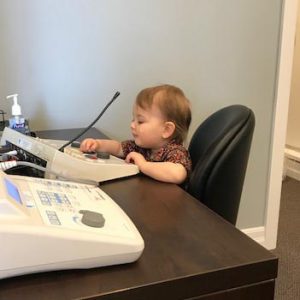 Child playing with an audiometer, pretending to do a hearing test