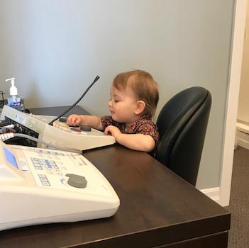 Child playing with an audiometer, pretending to do a hearing test