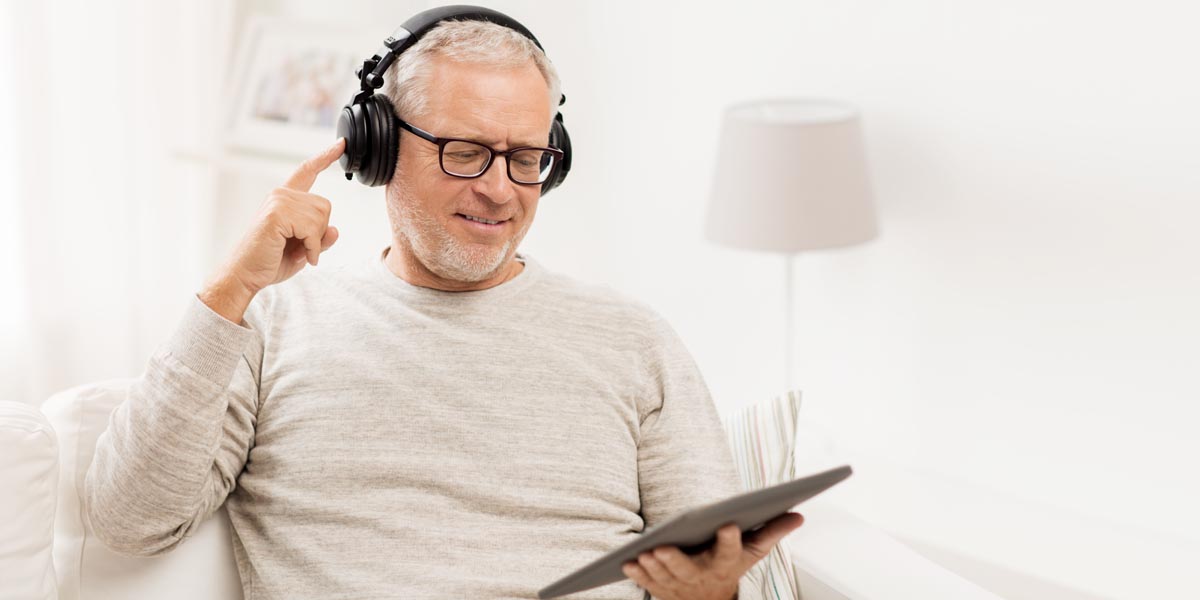 Man using headphones and our free online screener to check his hearing